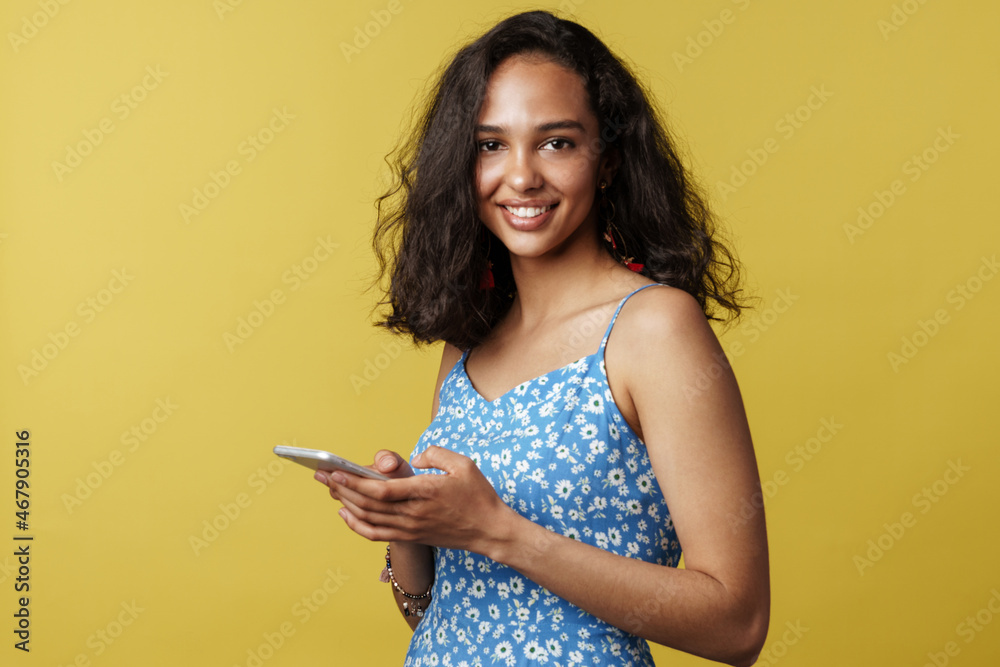 Young hispanic woman smiling while using mobile phone Young hispanic woman smiling while using mobile phone