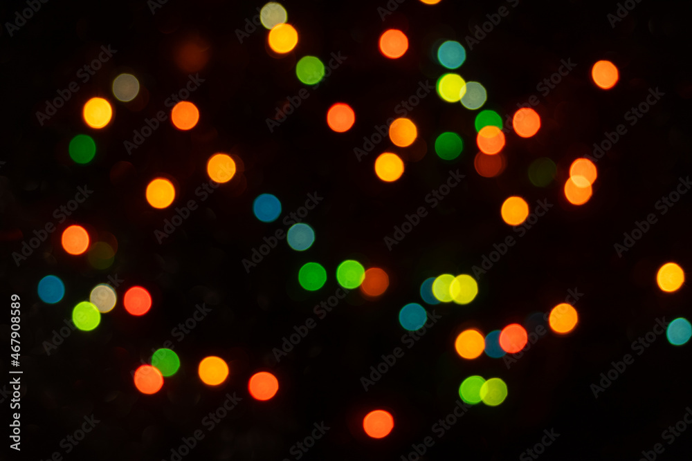 Obraz premium Defocused abstract yellow, green, orange and blue light circles. Bokeh is distributed throughout the frame