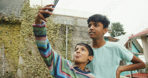 Photography Little brothers from India taking a selfie in Shimla, Himachal Pradesh, India