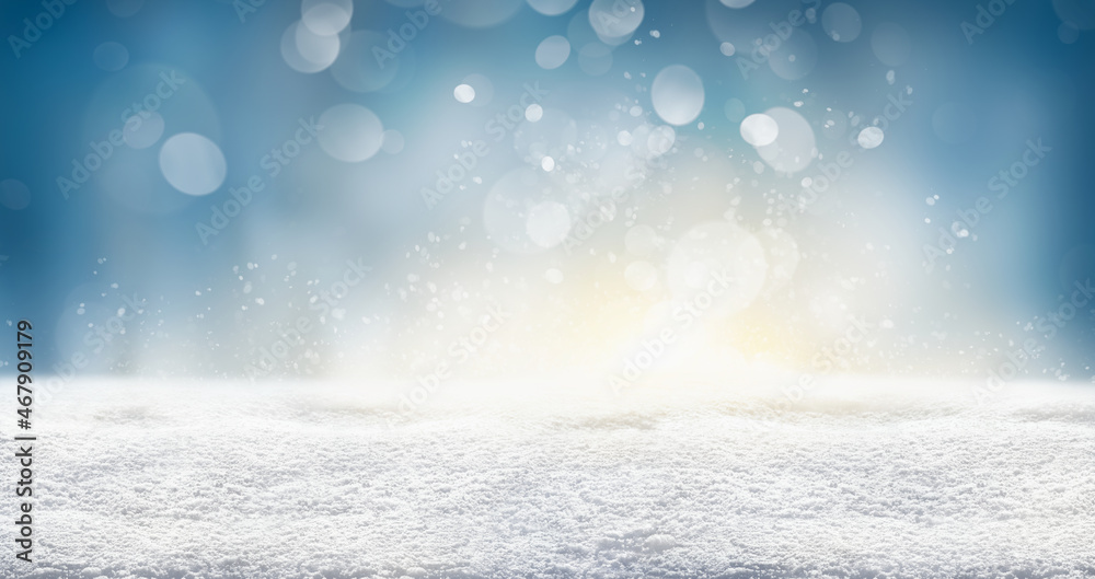 A cold winter snow landscape with sunny sky bokeh background for a traditional Christmas scene.