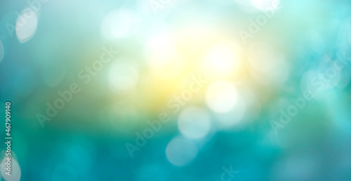 Obraz na płótnie A winter abstract sky background with cold wintery blue and sunshine yellow bokeh sparkling sun in the centre. w salonie