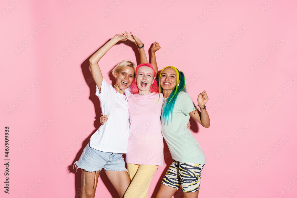 Young three women gesturing while making fun together on camera Young three women gesturing while making fun together on camera