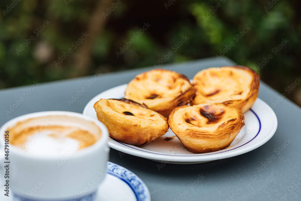 Egg custard tarts called Pasteis de Nata with two coffees Egg custard tarts called Pasteis de Nata with two coffees
