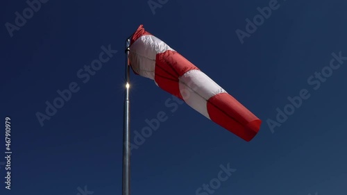 Windsock. Wind direction and intensity sign on helicopters and airfields. Wind cone used in aviation. Airport wind gauge.