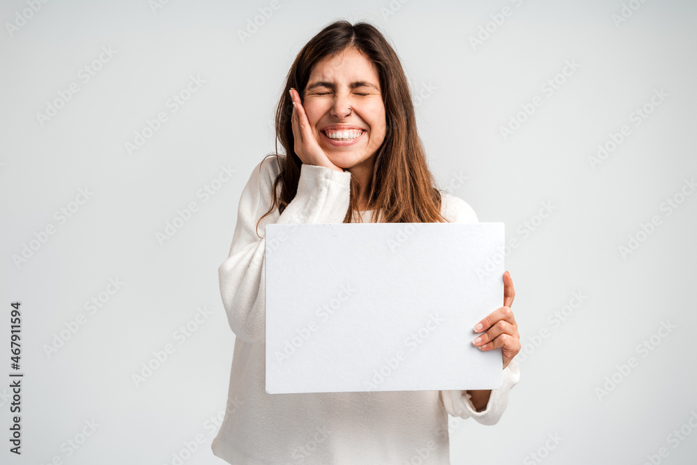 Photo of young happy positive woman holding empty billboard for advice choice isolated over white color background Photo of young happy positive woman holding empty billboard for advice choice isolated over white color background