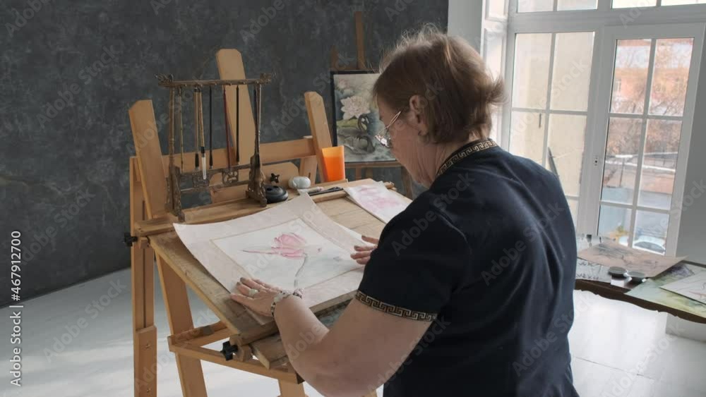 Senior Woman Artist Finishing Painting in Studio, Examining the Result of her Work. Creative Occupation, Retirement Hobby Concept