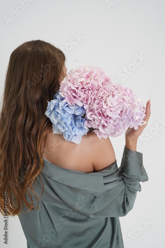 Girl holding flowers at the back, hydrangea