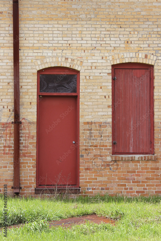 Close-up Building Detail Historical Brick Wall With Doors and Windows Close-up Building Detail Historical Brick Wall With Doors and Windows