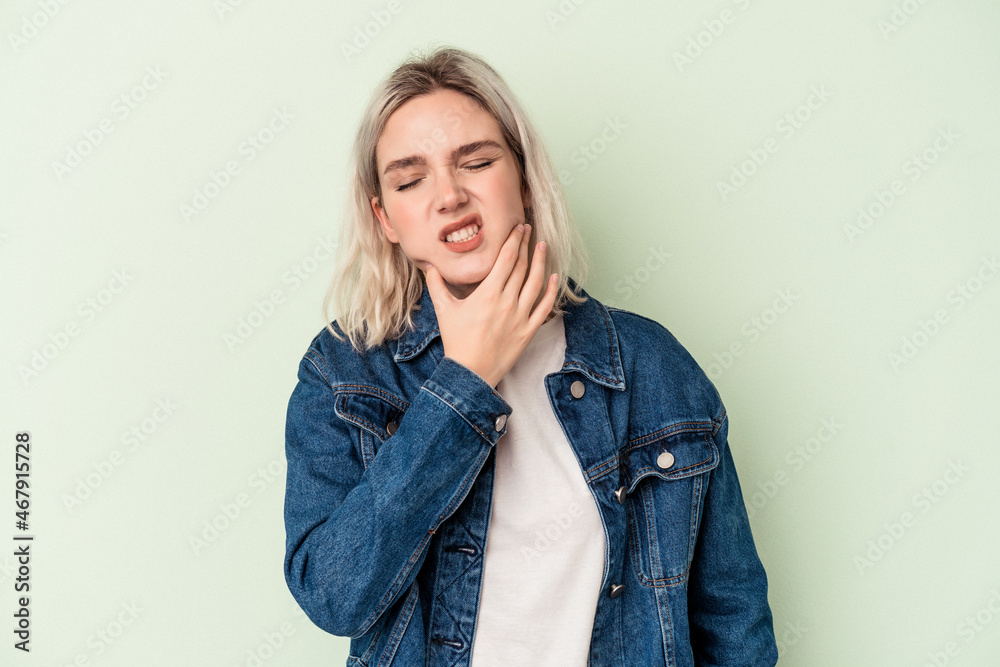 Young caucasian woman isolated on green background having a strong teeth pain, molar ache. Young caucasian woman isolated on green background having a strong teeth pain, molar ache.