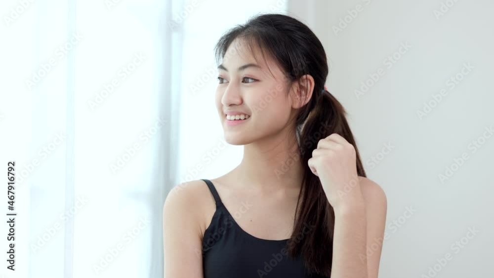 Young beautiful asian woman standing pose smiling look away outside. Sporty female workout and exercise wearing sport wear at home. Charming woman fitness relaxing after training and stretching. Young beautiful asian woman standing pose smiling look away outside. Sporty female workout and exercise wearing sport wear at home. Charming woman fitness relaxing after training and stretching.