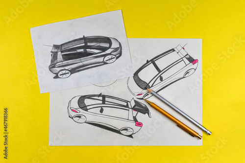 Car design sketches and pencils on yellow paper background