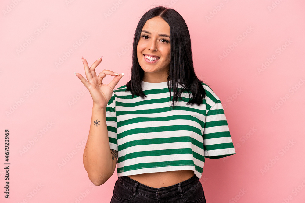 Young caucasian woman with one arm isolated on pink background cheerful and confident showing ok gesture. Young caucasian woman with one arm isolated on pink background cheerful and confident showing ok gesture.
