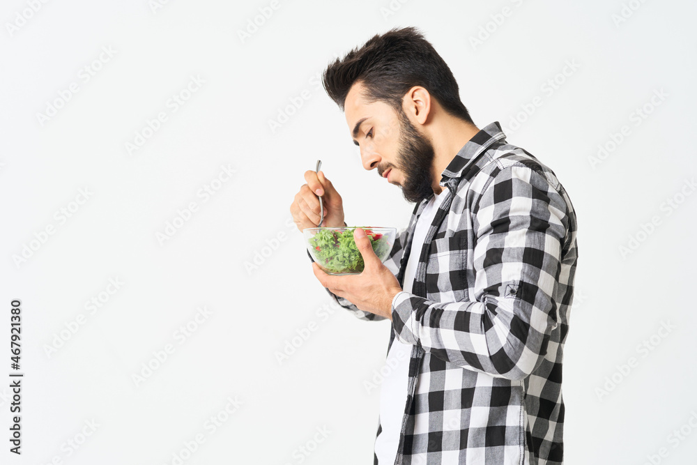 man in plaid shirt eating salad healthy food man in plaid shirt eating salad healthy food