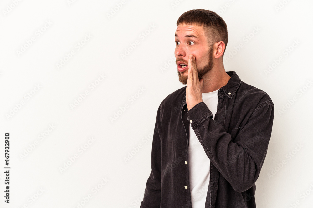 Young caucasian man with diastema isolated on white background being shocked because of something she has seen. Young caucasian man with diastema isolated on white background being shocked because of something she has seen.