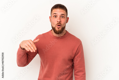 Young caucasian man with diastema isolated on white background laughing about something, covering mouth with hands.