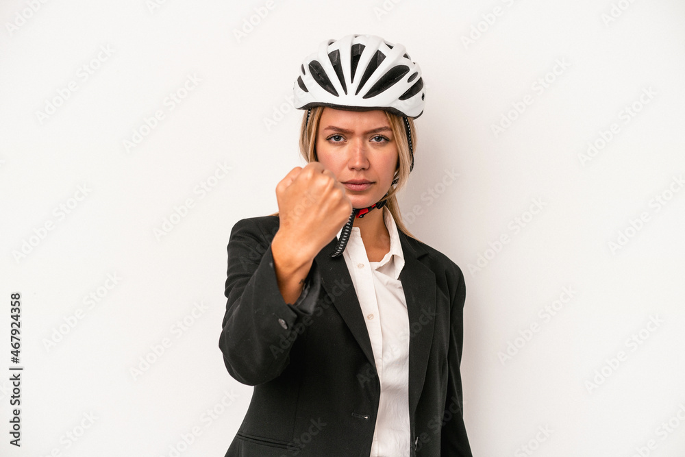 Young caucasian business woman wearing a bike helmet isolated on white background showing fist to camera, aggressive facial expression.