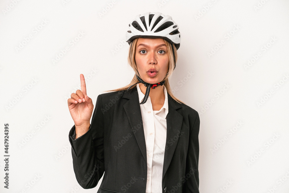 Young caucasian business woman wearing a bike helmet isolated on white background having some great idea, concept of creativity. Young caucasian business woman wearing a bike helmet isolated on white background having some great idea, concept of creativity.