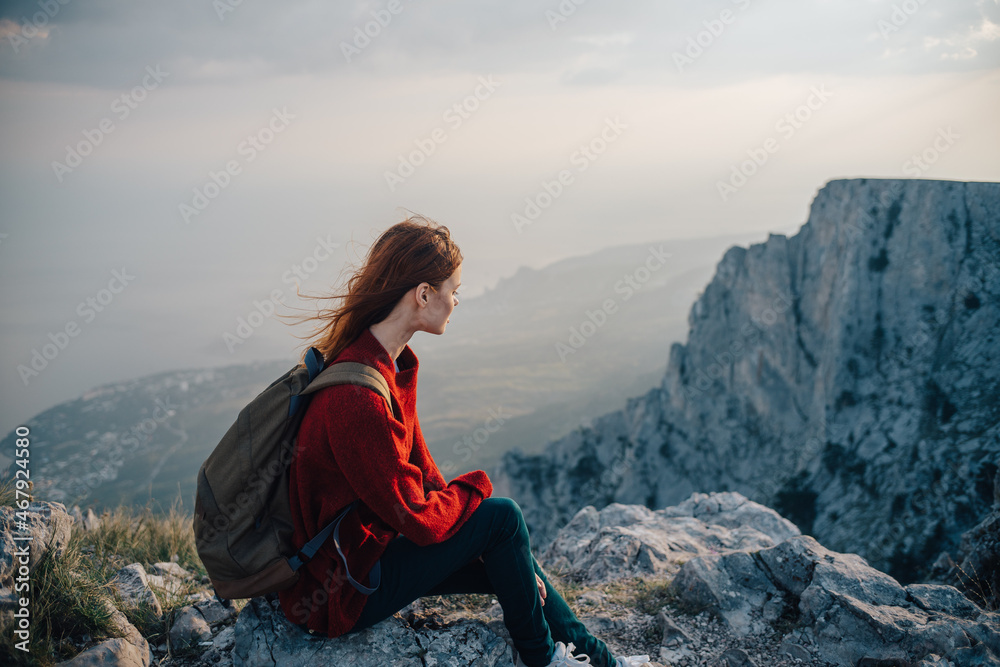woman with backpack in mountains at altitude landscape nature