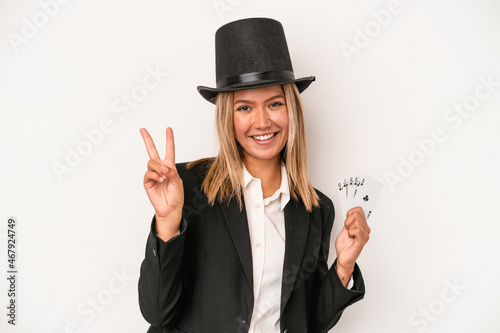 Young caucasian wizard woman holding magic card isolated on white background showing number two with fingers.