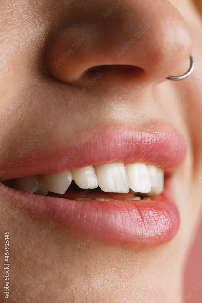 Naklejka premium Close-up female mouth and nose isolated over pink studio background. Natural beauty concept. Dental health concept