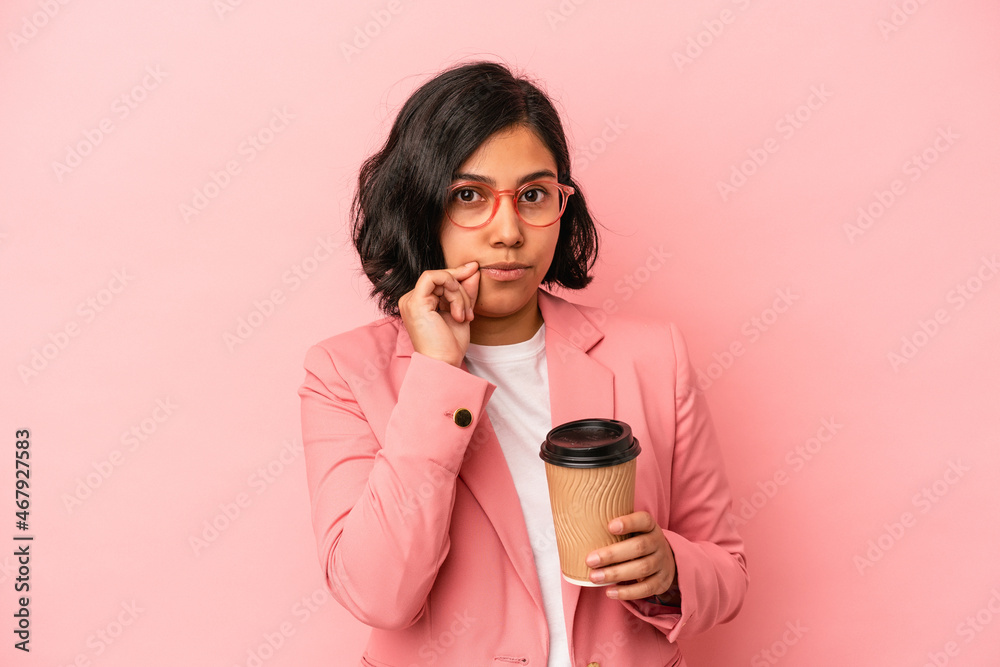 Young latin woman holding take away coffee isolated on pink background with fingers on lips keeping a secret. Young latin woman holding take away coffee isolated on pink background with fingers on lips keeping a secret.