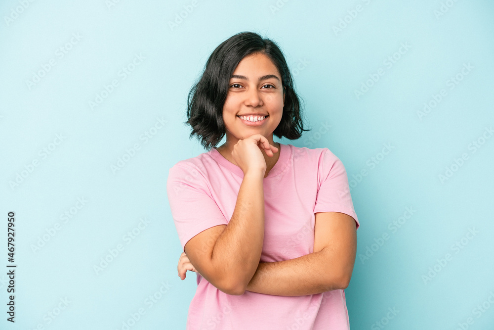 Young latin woman isolated on blue background smiling happy and confident, touching chin with hand. Young latin woman isolated on blue background smiling happy and confident, touching chin with hand.