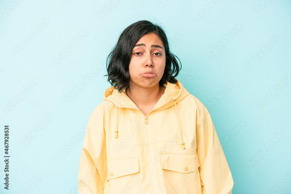 Young latin woman isolated on blue background sad, serious face, feeling miserable and displeased. Young latin woman isolated on blue background sad, serious face, feeling miserable and displeased.