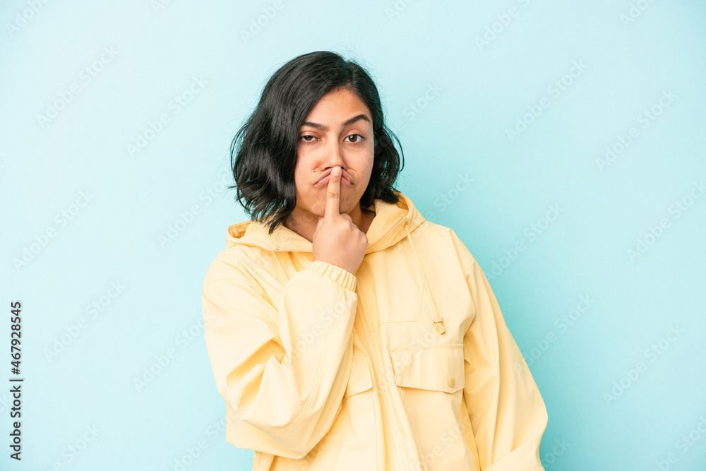 Young latin woman isolated on blue background thinking and looking up, being reflective, contemplating, having a fantasy. Young latin woman isolated on blue background thinking and looking up, being reflective, contemplating, having a fantasy.