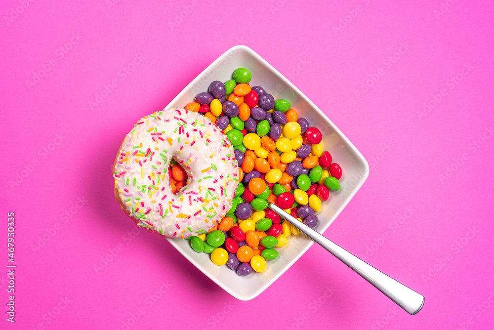 Donut with bowl full of colorful sweets.  - obrazy, fototapety, plakaty 