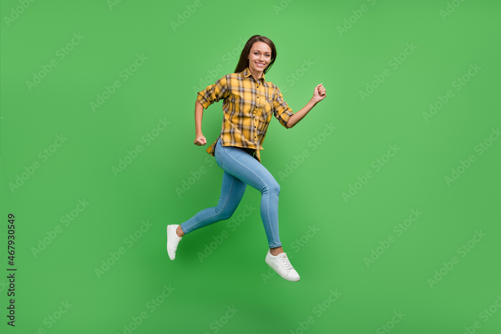 Full body profile portrait of overjoyed pretty lady running beaming smile look camera isolated on green color background Full body profile portrait of overjoyed pretty lady running beaming smile look camera isolated on green color background
