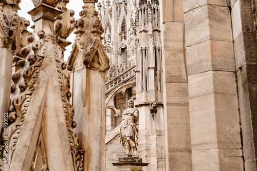 Statue of a noble commander in beautiful clothes on the facade of the Duomo. Italy, Milan