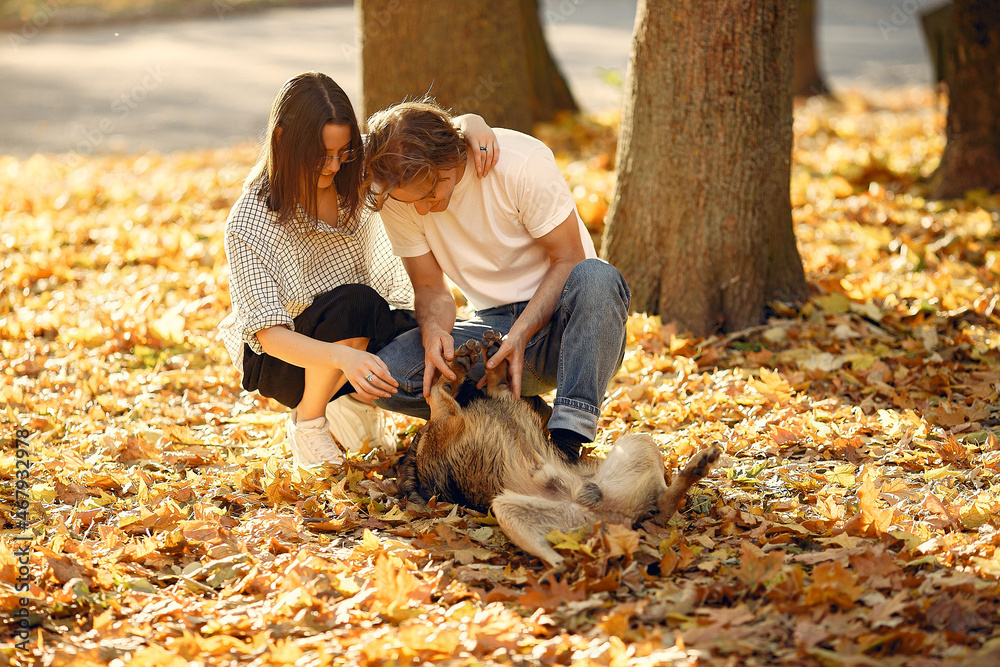 Fototapeta premium Beautiful couple spend time in a autumn park