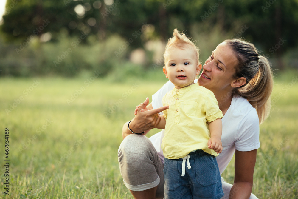 Fototapeta premium mother and her baby boy in public park