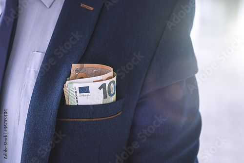 Business man holding euro bills in office © RomanR
