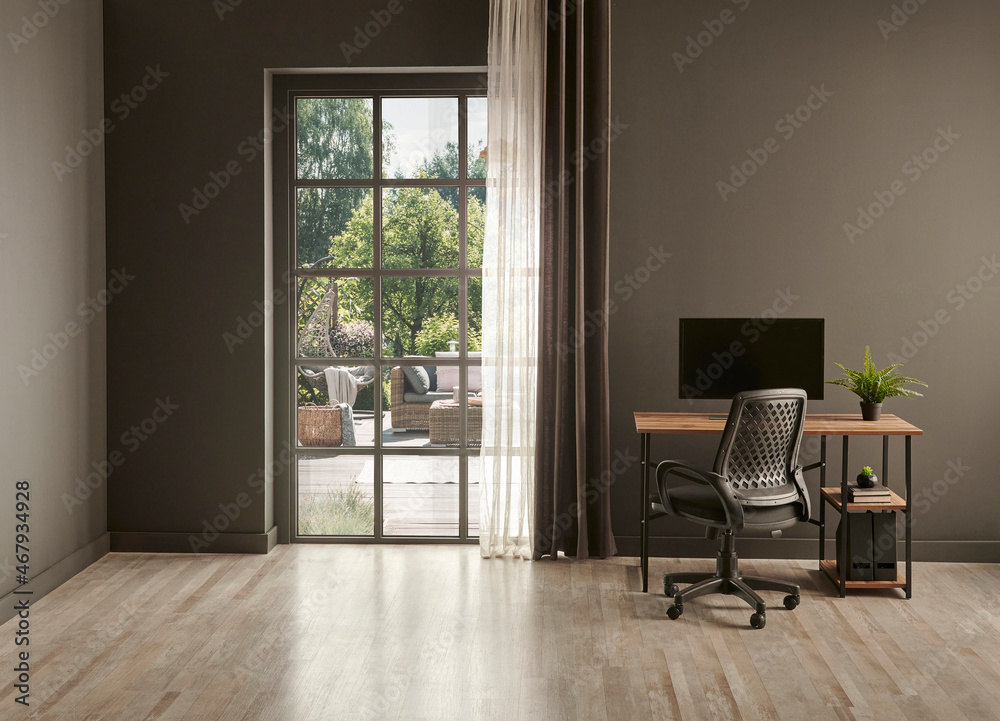 Fototapeta premium Grey living room office, monitor, chair vase of green plant in front of the window garden view.