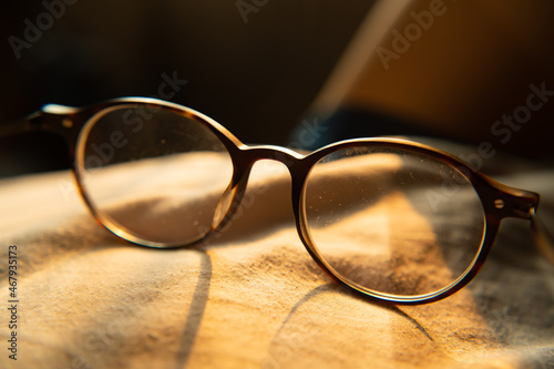 Eyeglasses with dusty lens in warm sunlight