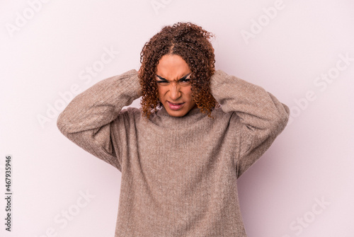 Young latin transsexual woman isolated on pink background covering ears with hands. © Asier
