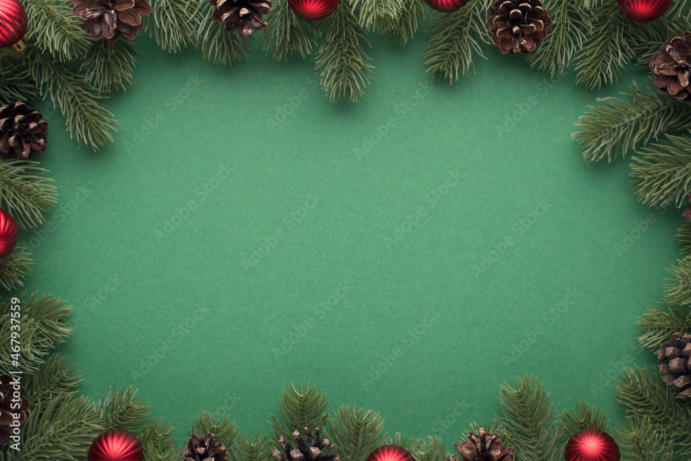 Top view photo of pine branches with cones and red christmas tree balls ...