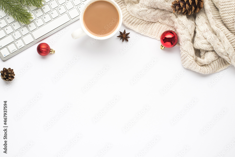 Naklejka premium Top view photo of keyboard cup of hot drinking red christmas tree balls pine twig cone anise and cozy sweater on isolated white background with copyspace