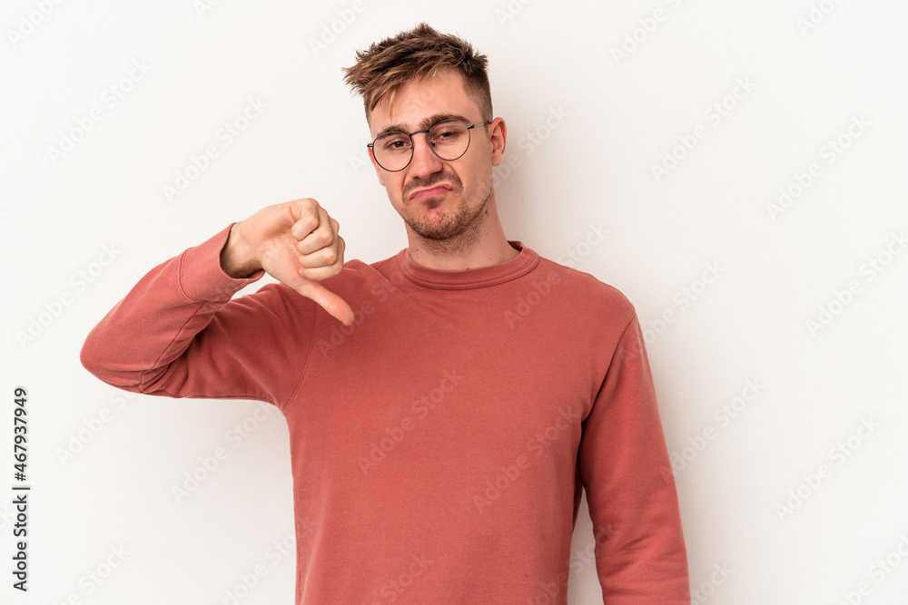 Young caucasian man isolated on white background showing thumb down, disappointment concept. Young caucasian man isolated on white background showing thumb down, disappointment concept.