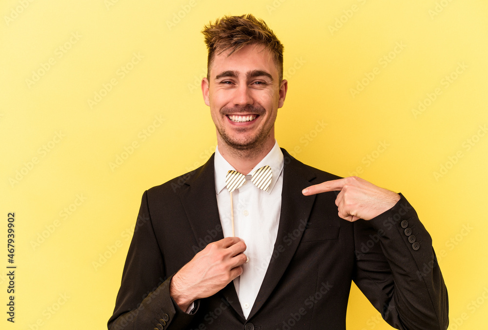 Young caucasian man celebrating new year isolated on yellow background Young caucasian man celebrating new year isolated on yellow background