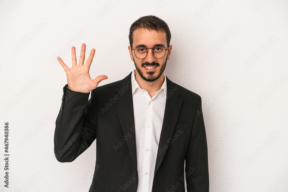 Young caucasian business man isolated on white background smiling cheerful showing number five with fingers. Young caucasian business man isolated on white background smiling cheerful showing number five with fingers.