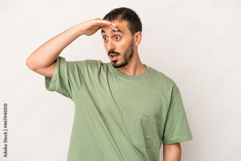 Young caucasian man isolated on white background looking far away keeping hand on forehead. Young caucasian man isolated on white background looking far away keeping hand on forehead.