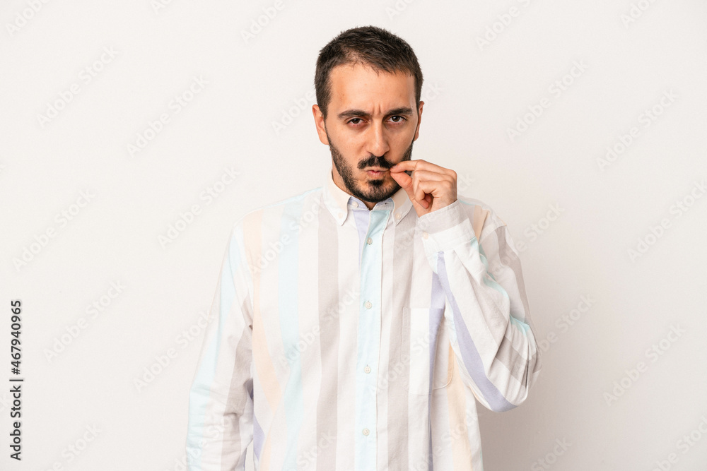 Young caucasian man isolated on white background with fingers on lips keeping a secret. Young caucasian man isolated on white background with fingers on lips keeping a secret.