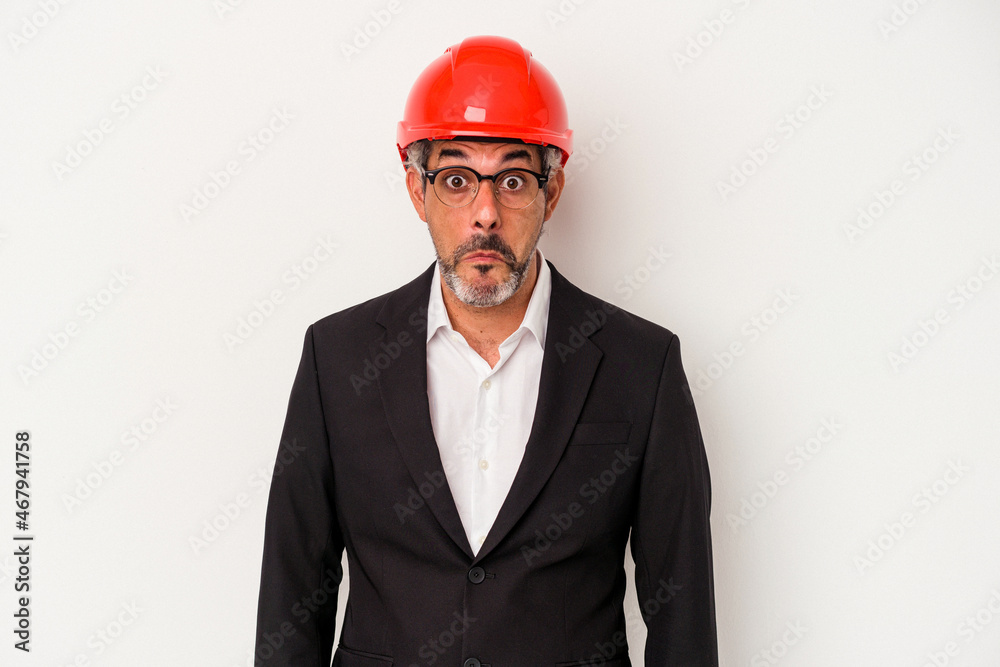 Middle age architect caucasian man isolated on white background shrugs shoulders and open eyes confused. Middle age architect caucasian man isolated on white background shrugs shoulders and open eyes confused.