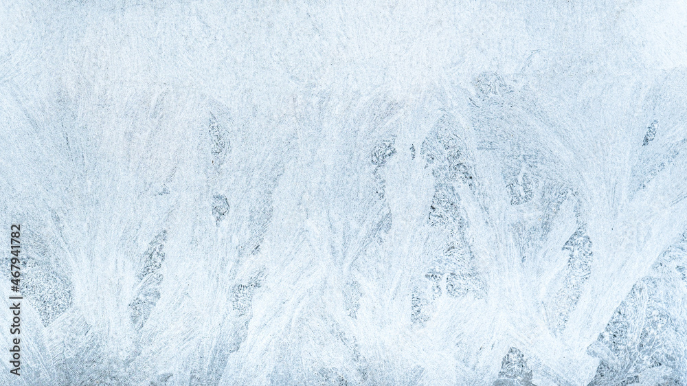 Ice pattern background. Cold winter. Christmas wonder. Extreme north. Abstract decorative frost snowflake crystals tracery on frozen white blue window pane glass surface. Ice pattern background. Cold winter. Christmas wonder. Extreme north. Abstract decorative frost snowflake crystals tracery on frozen white blue window pane glass surface.