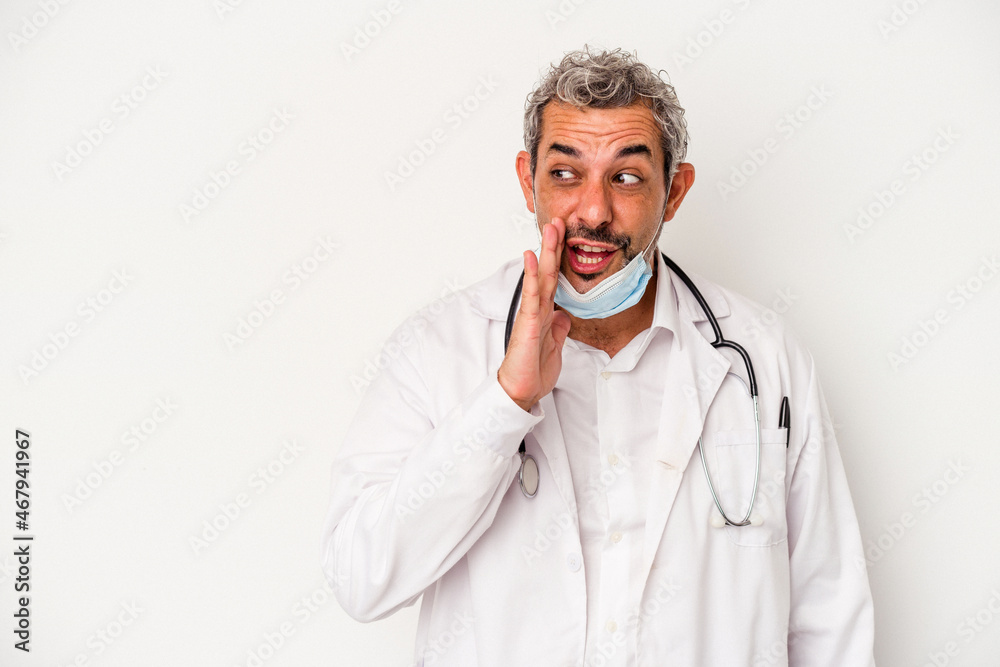 Middle age doctor man wearing a mask for virus isolated on white background is saying a secret hot braking news and looking aside Middle age doctor man wearing a mask for virus isolated on white background is saying a secret hot braking news and looking aside