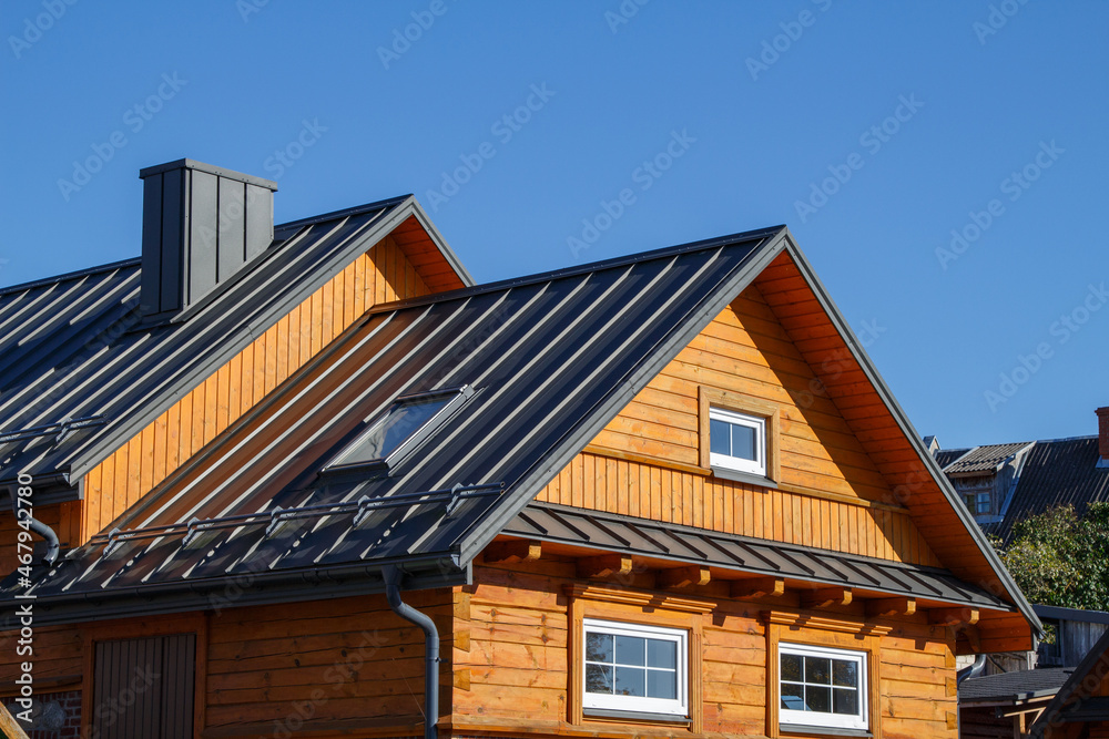Wooden houses. Classic metal roof. Colorful Houses Wooden houses. Classic metal roof. Colorful Houses