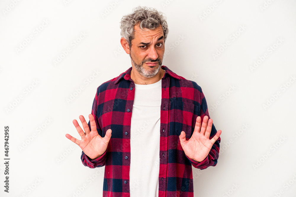 Middle age caucasian man isolated on white background rejecting someone showing a gesture of disgust. Middle age caucasian man isolated on white background rejecting someone showing a gesture of disgust.