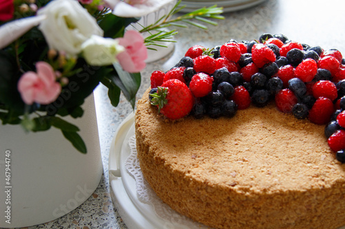 Cake decorated with fresh berries.  Honey cake. photo